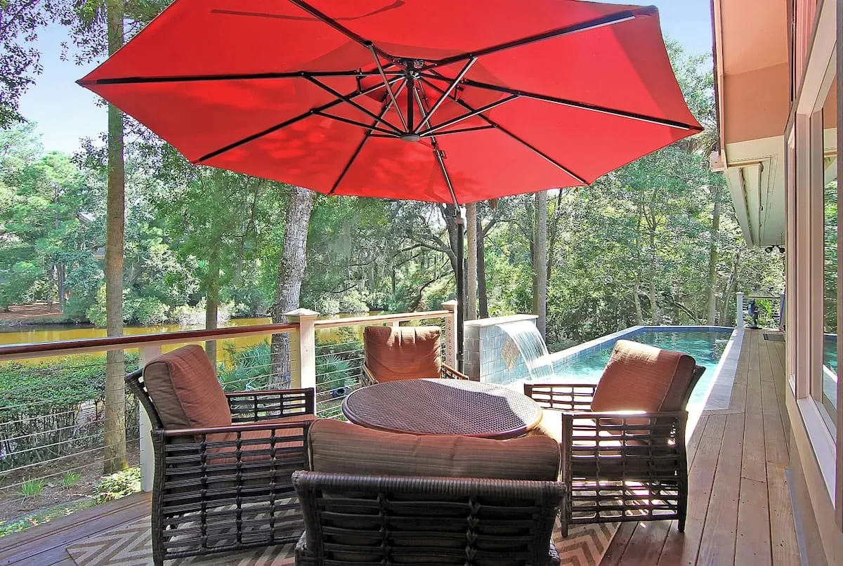 Deck with wicker furniture and red umbrella